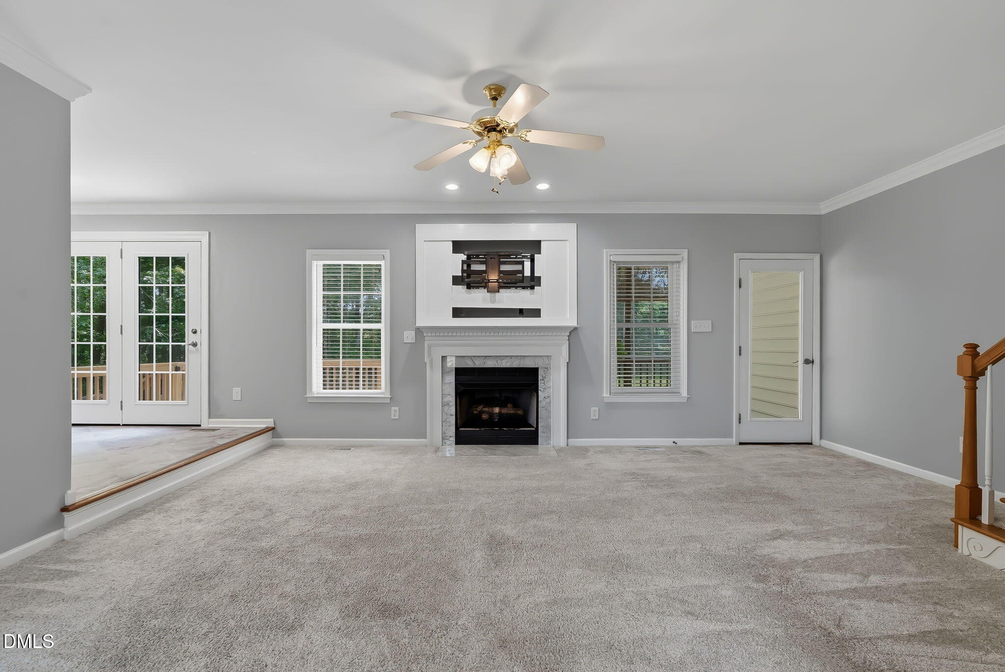 1112 Tyler Farms Drive Raleigh, NC 27603 - Photo 16 of 78 a view of a livingroom with a fireplace a ceiling fan and windows