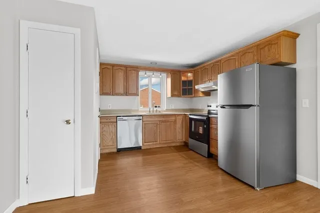 a kitchen with stainless steel appliances a refrigerator sink and cabinets