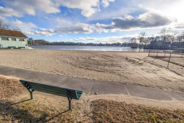 a view of a lake with beach and city view