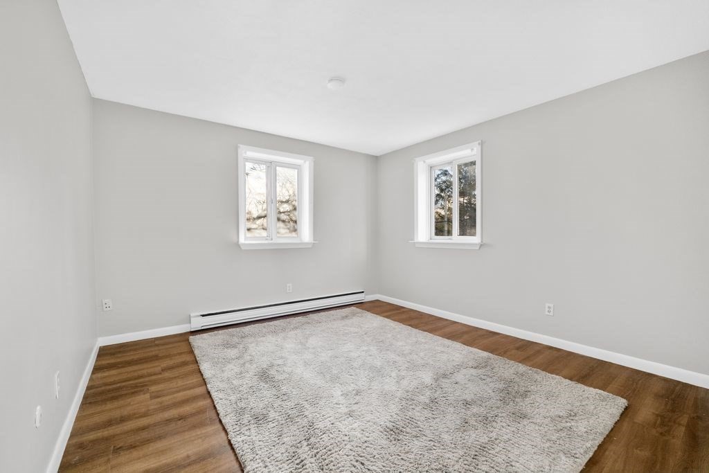 133 Winthrop Street, Unit 21 Framingham, MA 01702 - Photo 5 of 15 an empty room with windows