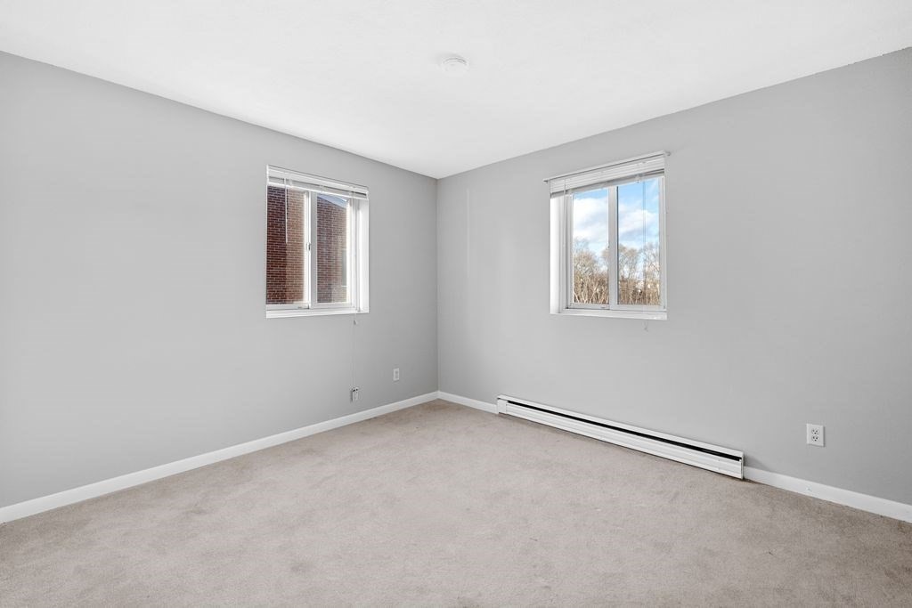 133 Winthrop Street, Unit 21 Framingham, MA 01702 - Photo 6 of 15 an empty room with windows
