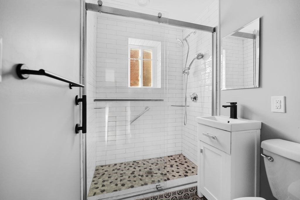 133 Winthrop Street, Unit 21 Framingham, MA 01702 - Photo 7 of 15 a bathroom with a sink a toilet a shower and a mirror