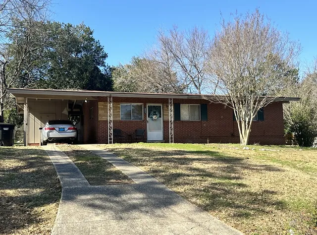 a view of a house with a yard covered in snow