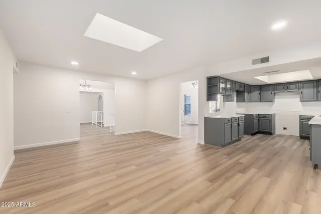 a view of a kitchen with a sink and a refrigerator