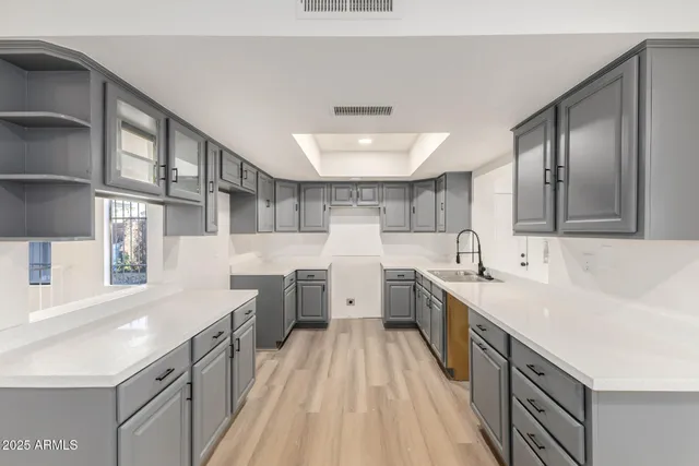a large white kitchen with a lot of counter space
