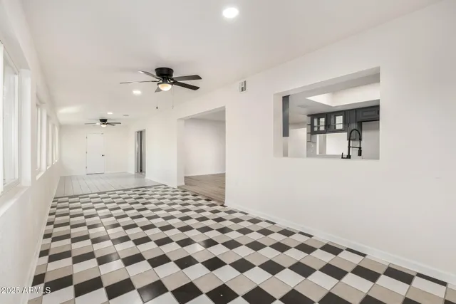 a bathroom with a black and white checkered floor
