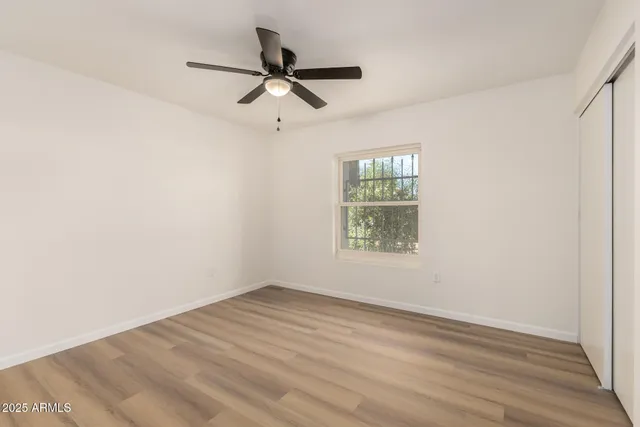 wooden floor in an empty room with a window