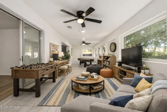 a living room with furniture a rug and a flat screen tv