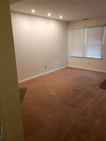 an empty room with a empty space and window
