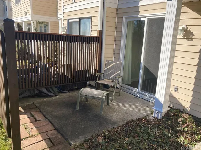 a view of a patio with a table and chairs and wooden floor