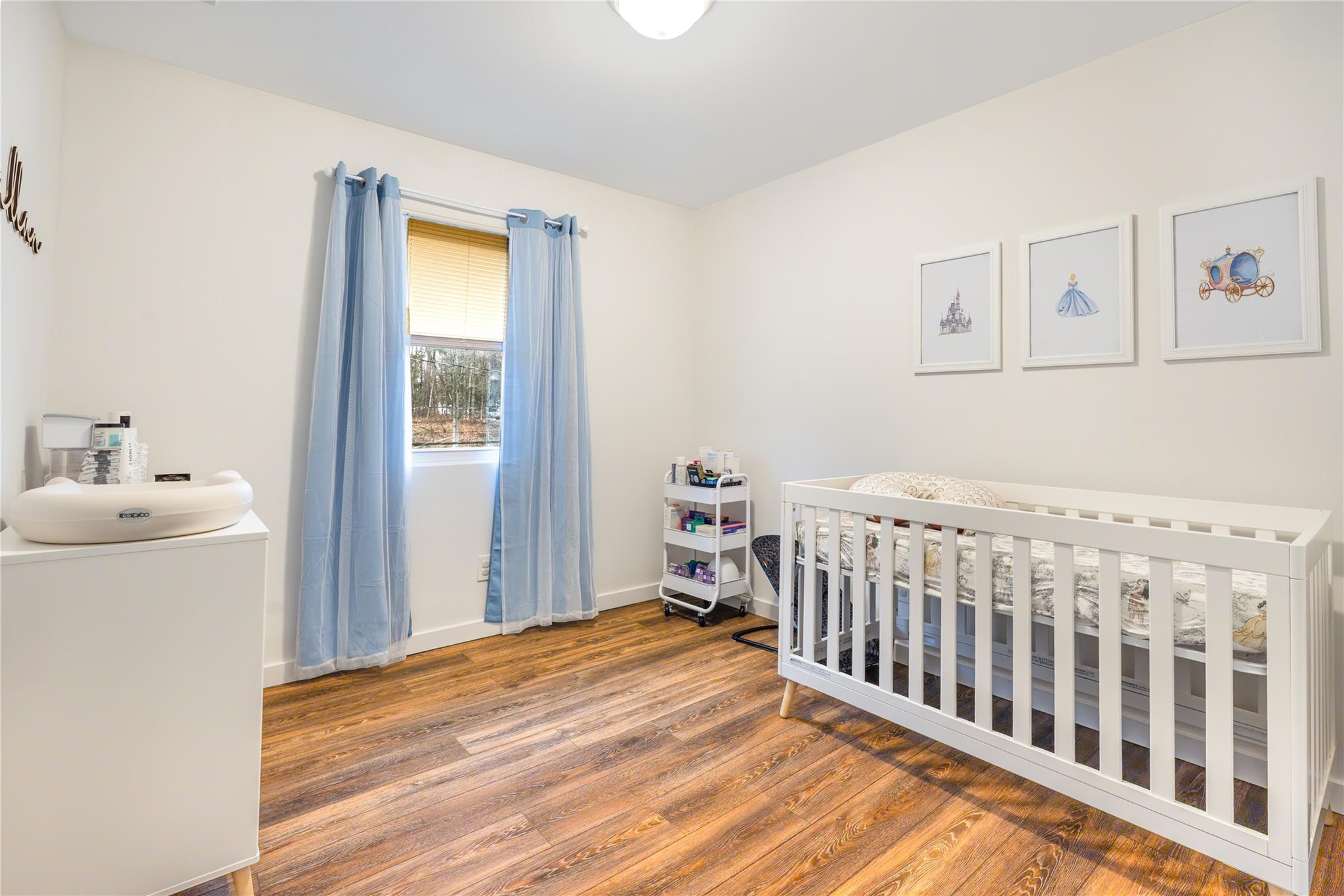 45 Raker Road Poughkeepsie, NY 12603 - Photo 14 of 25 Bedroom with baseboards, wood finished floors, and a nursery area
