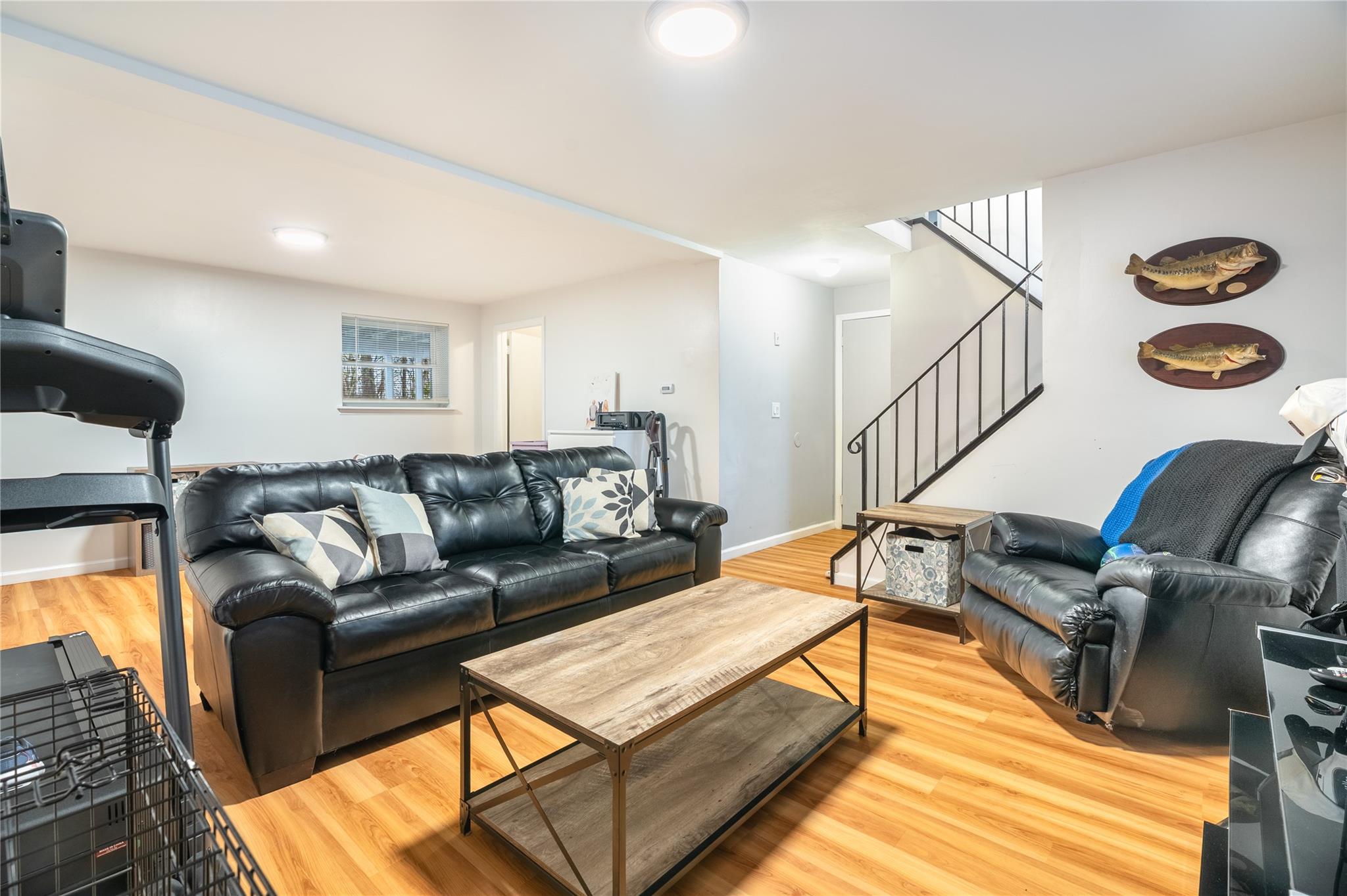 45 Raker Road Poughkeepsie, NY 12603 - Photo 19 of 25 Living room with baseboards, light wood-style floors, and stairway