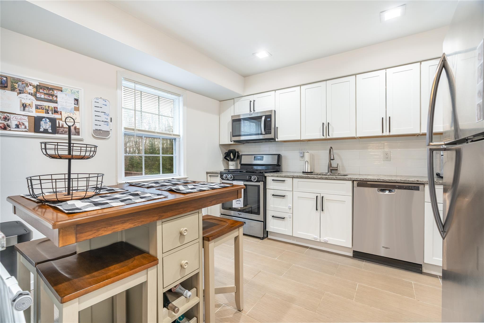 45 Raker Road Poughkeepsie, NY 12603 - Photo 8 of 25 Kitchen featuring white cabinetry, backsplash, a sink, and stainless steel appliances