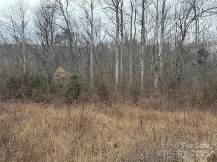 a view of staircase with railing and white walls