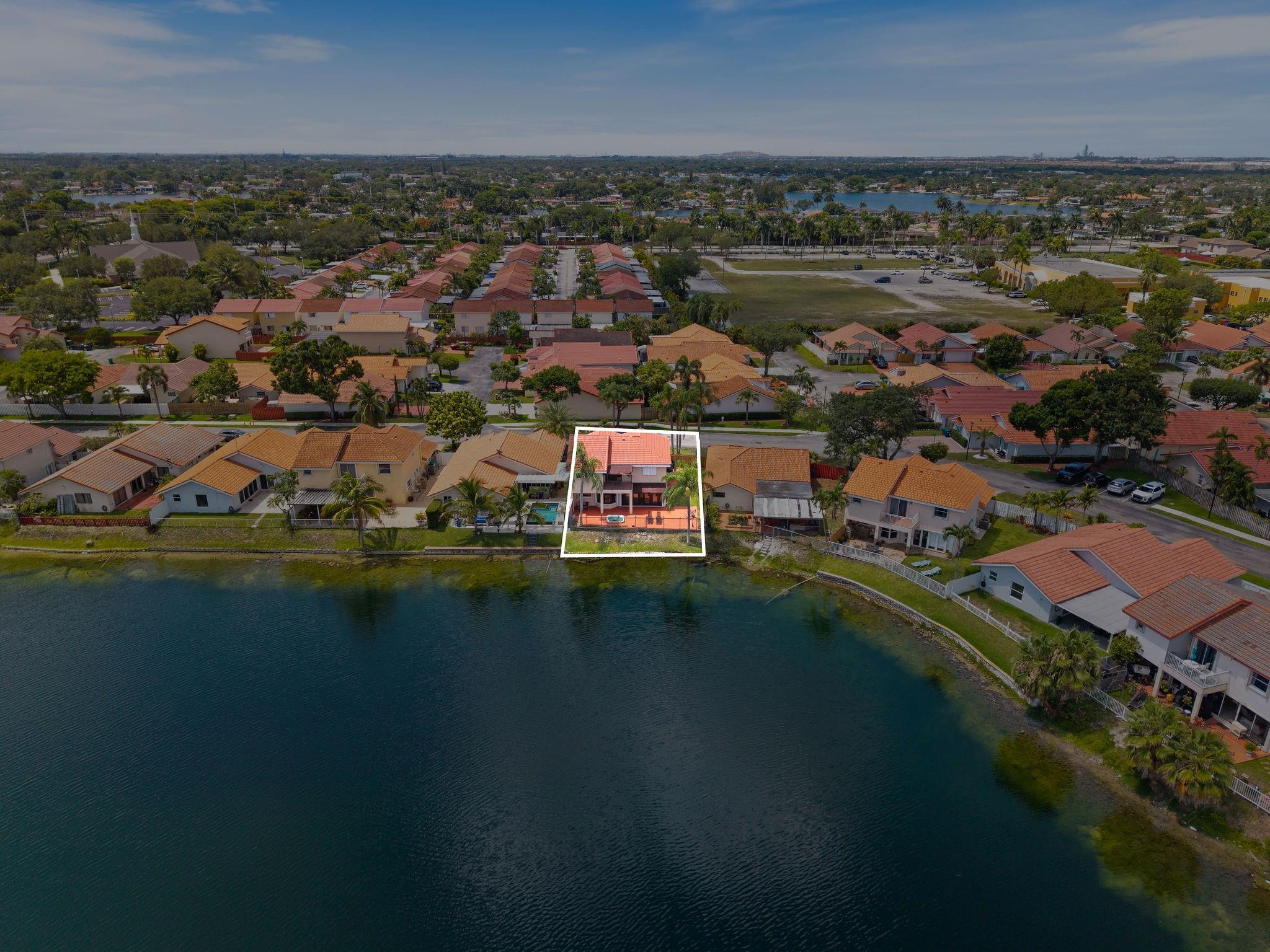 8313 Northwest 188th Terrace Hialeah, FL 33015 - Photo 13 of 50 an aerial view of residential houses with outdoor space and lake view