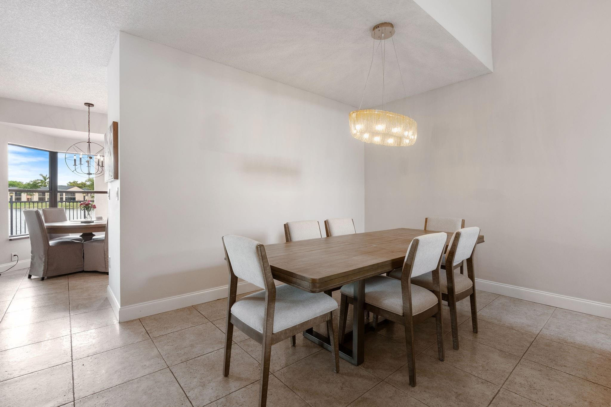 8313 Northwest 188th Terrace Hialeah, FL 33015 - Photo 20 of 50 a dining room with furniture and chandelier