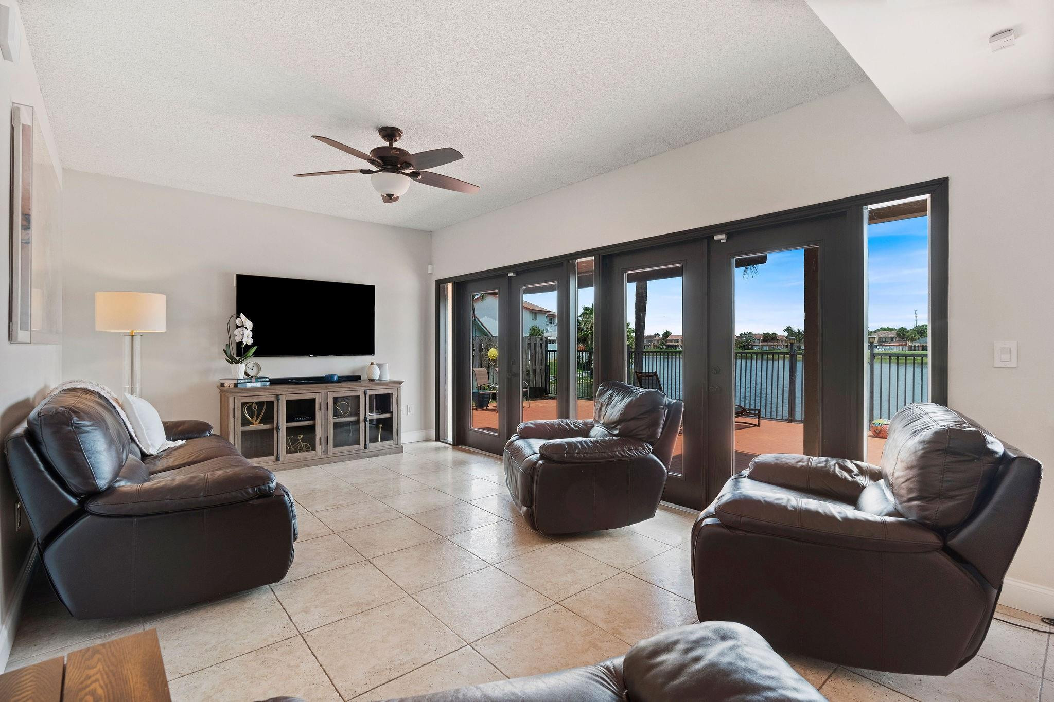 8313 Northwest 188th Terrace Hialeah, FL 33015 - Photo 23 of 50 a living room with furniture a flat screen tv and floor to ceiling window