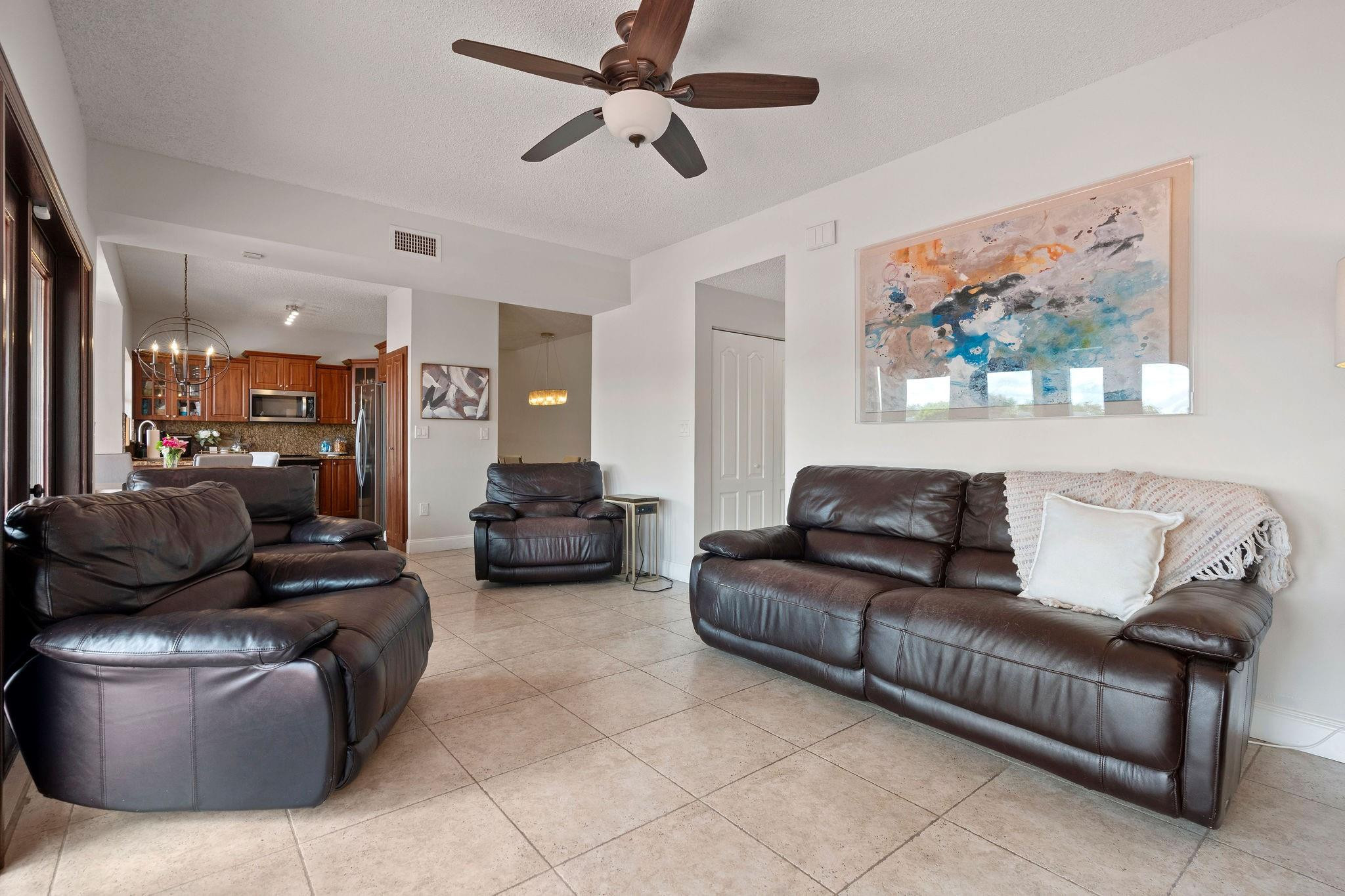8313 Northwest 188th Terrace Hialeah, FL 33015 - Photo 24 of 50 a living room with furniture and a ceiling fan