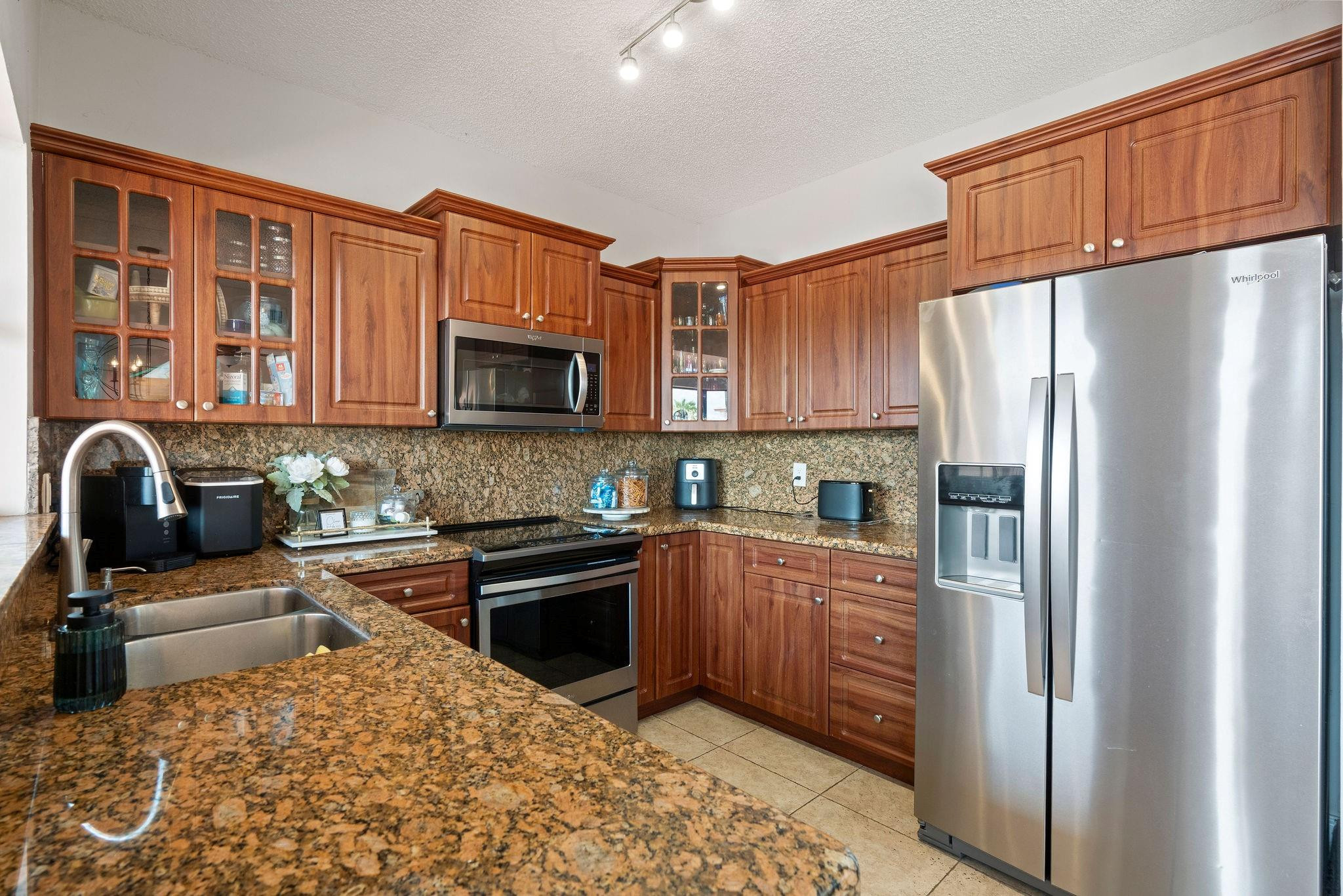 8313 Northwest 188th Terrace Hialeah, FL 33015 - Photo 27 of 50 a kitchen with stainless steel appliances granite countertop a refrigerator stove top oven and sink