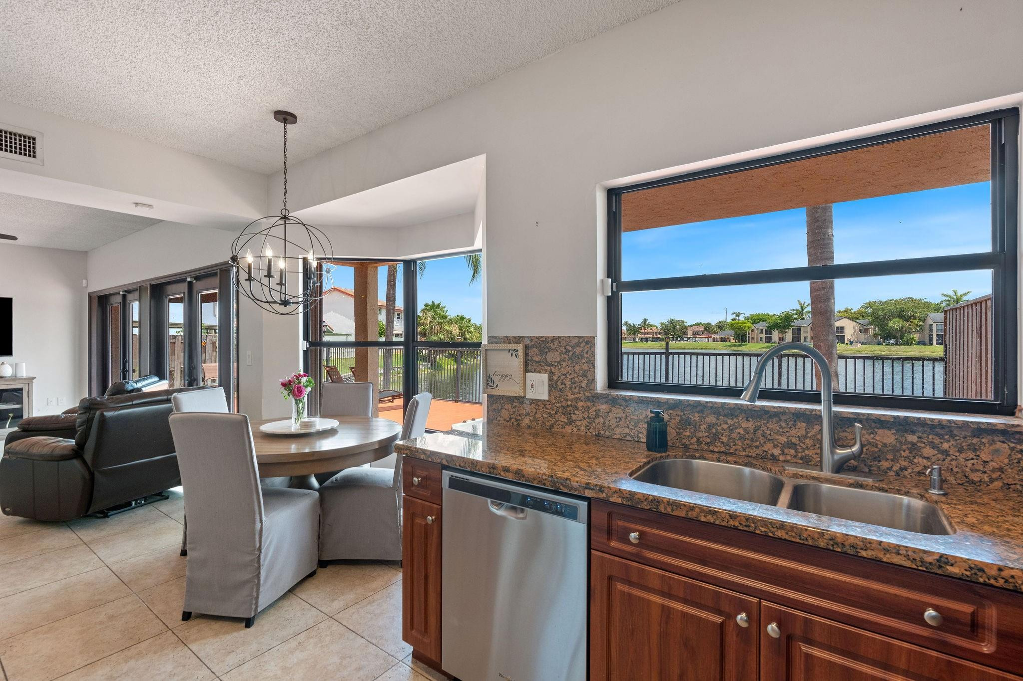 8313 Northwest 188th Terrace Hialeah, FL 33015 - Photo 29 of 50 a dining hall with stainless steel appliances granite countertop a sink and dishwasher next to a large window