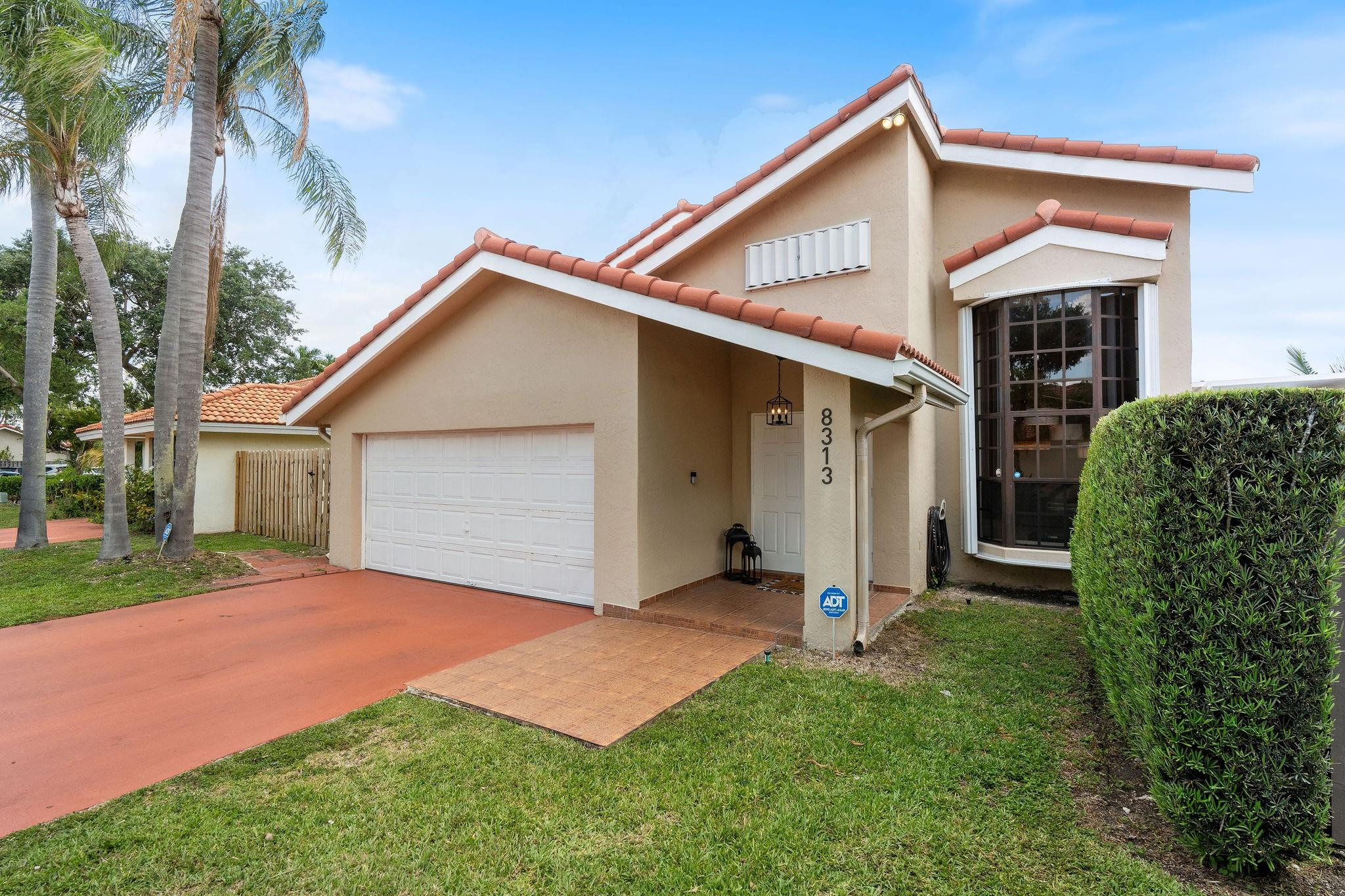 8313 Northwest 188th Terrace Hialeah, FL 33015 - Photo 3 of 50 a front view of house with yard and green space