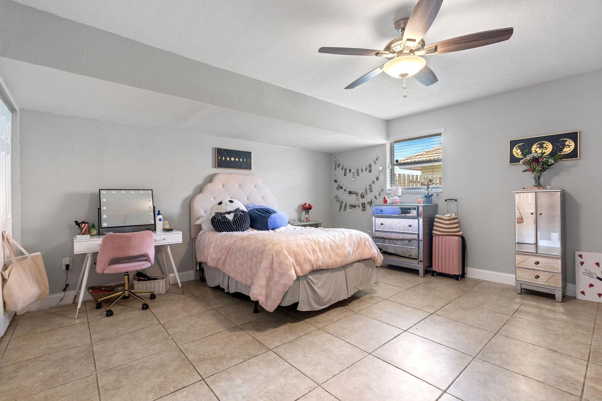 8313 Northwest 188th Terrace Hialeah, FL 33015 - Photo 33 of 50 a spacious bedroom with a bed and a chair