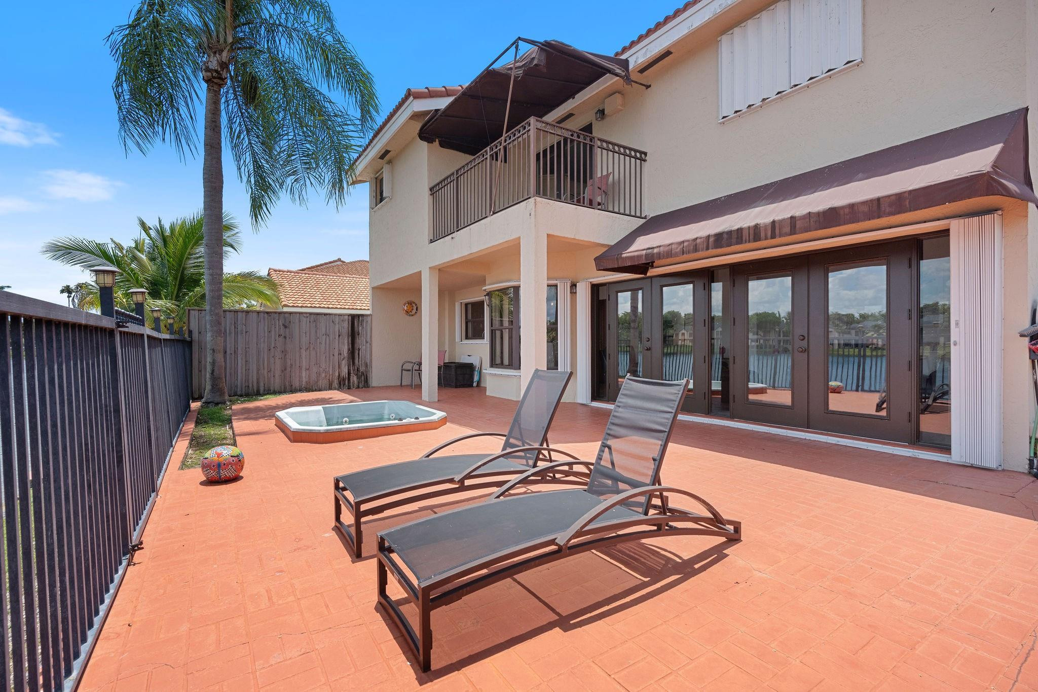 8313 Northwest 188th Terrace Hialeah, FL 33015 - Photo 48 of 50 a view of a patio with swimming pool table and chairs