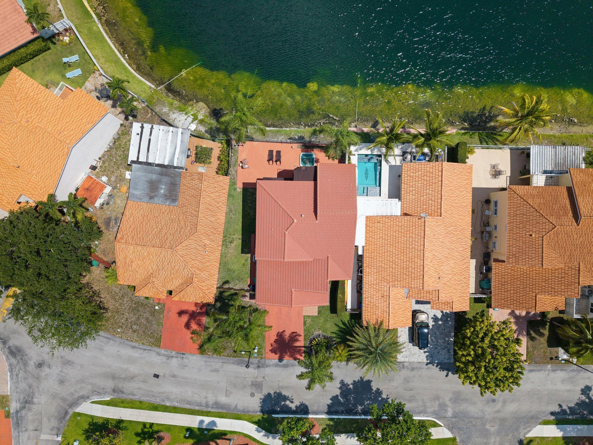 8313 Northwest 188th Terrace Hialeah, FL 33015 - Photo 7 of 50 an aerial view of residential houses with outdoor space and swimming pool