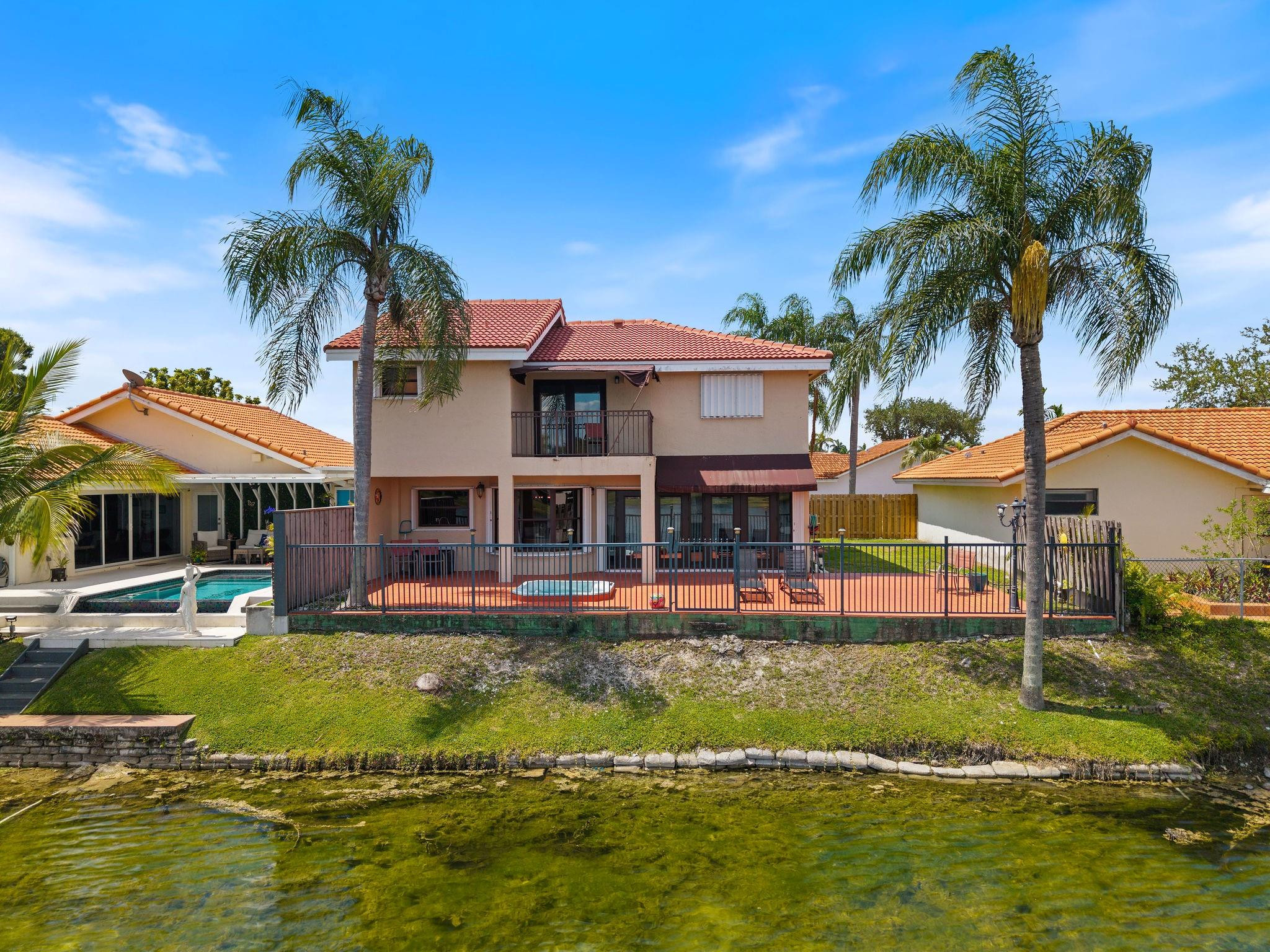 8313 Northwest 188th Terrace Hialeah, FL 33015 - Photo 8 of 50 a view of a house with swimming pool and a yard