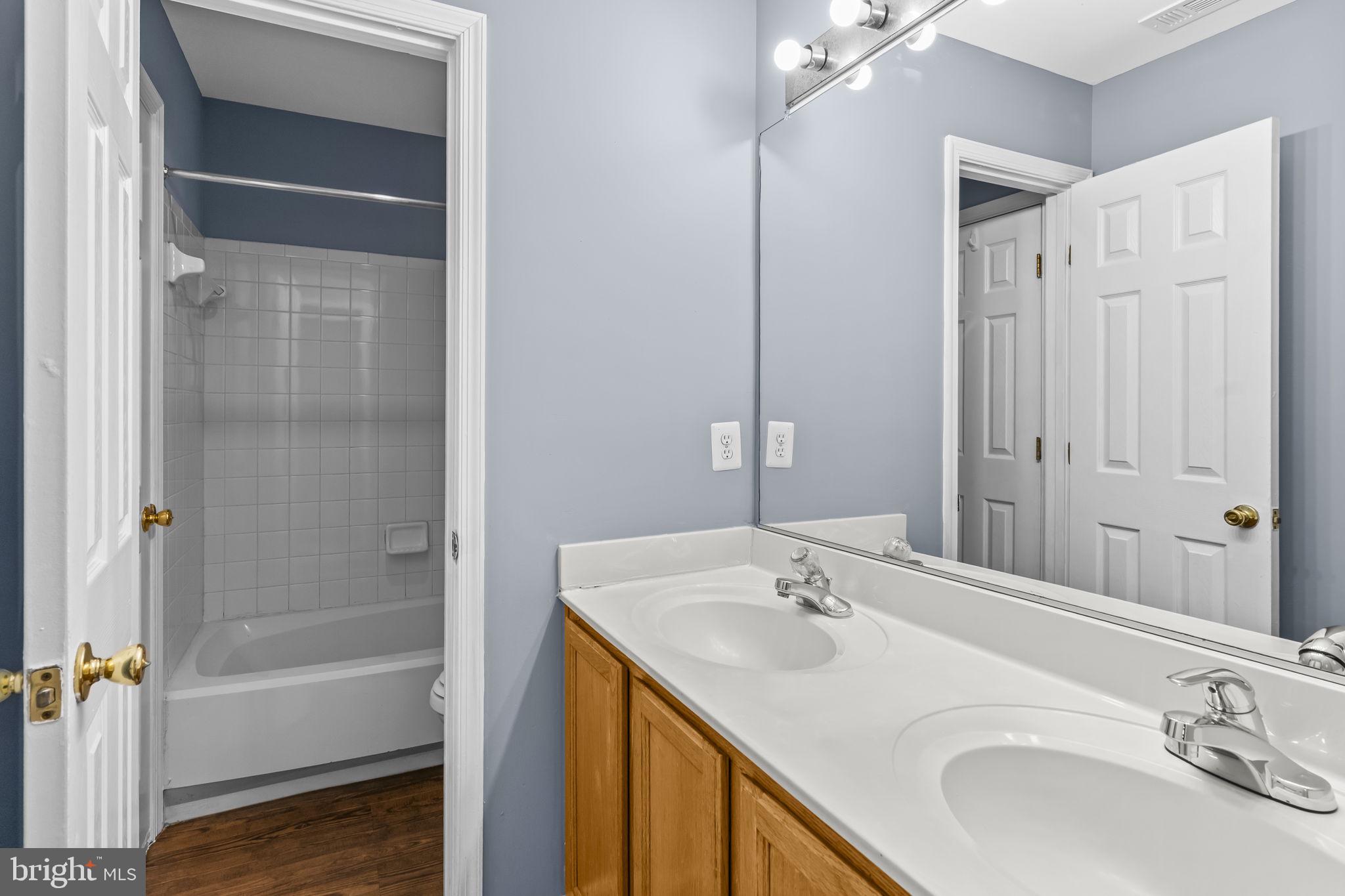 13192 Ripon Place Upper Marlboro, MD 20772 - Photo 15 of 23 a bathroom with a tub sink and mirror
