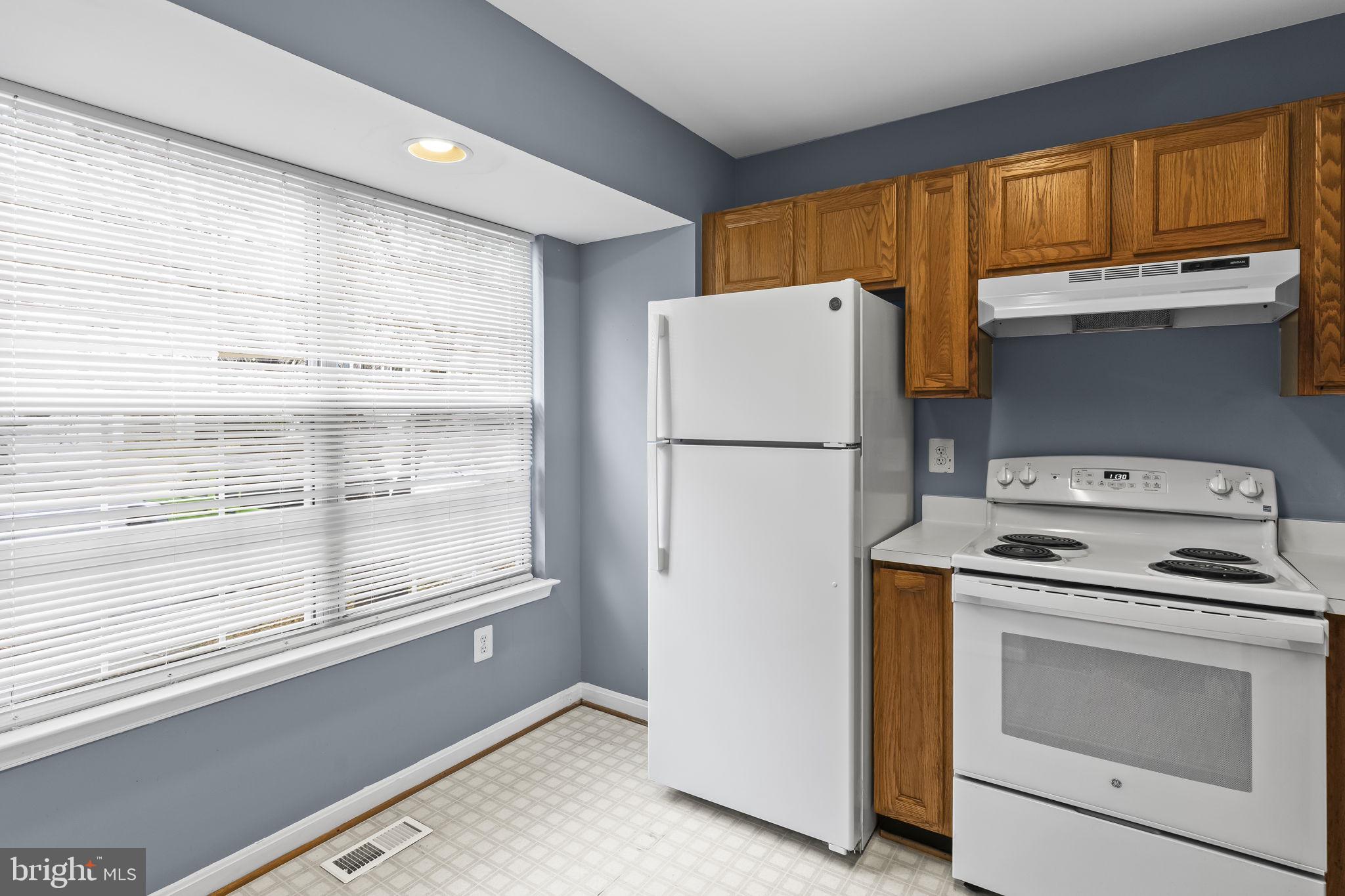 13192 Ripon Place Upper Marlboro, MD 20772 - Photo 3 of 23 a kitchen with a refrigerator a stove and a window