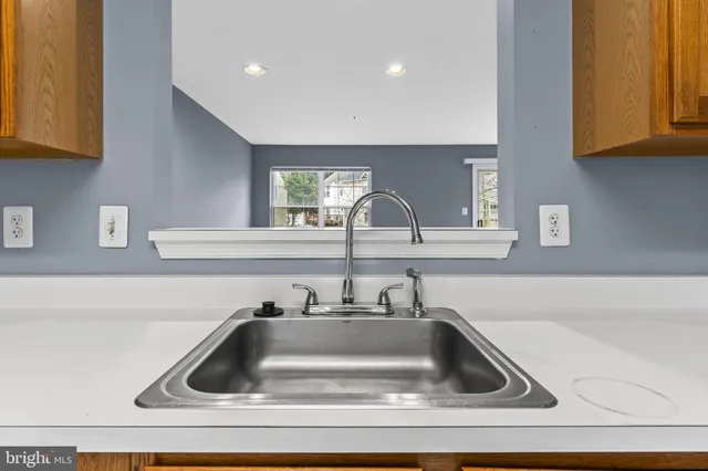 a kitchen with sink and cabinets