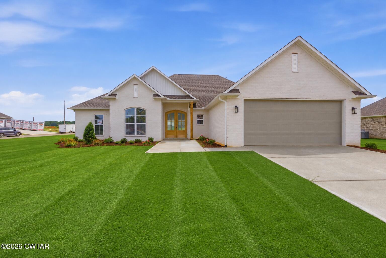 179 Daybreak Loop Medina, TN 38355 - Photo 1 of 32 a front view of house with yard and green space