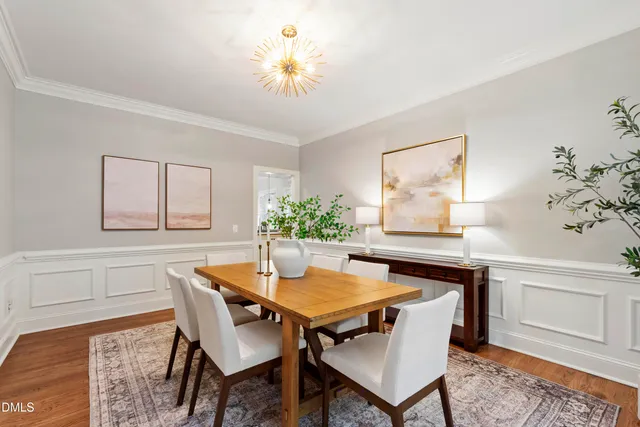 a kitchen with stainless steel appliances granite countertop a stove a refrigerator a sink a oven and a wooden floor