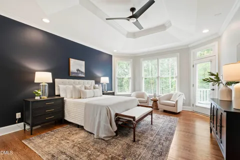 an empty room with a chandelier fan and windows