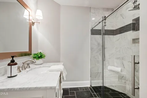 a front view of a house with a garden and trees