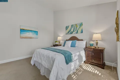 a bedroom with a bed and a lamp