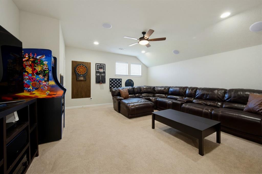2721 Old Shire Path Road Prosper, TX 75078 - Photo 20 of 39 Spacious media/ game room featuring vaulted ceilings, recessed lighting, a ceiling fan, and carpeted flooring