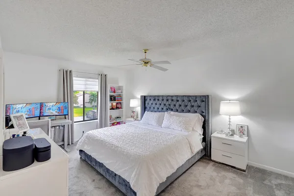 a large bed sitting in a bedroom and table