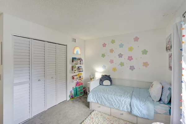 a bedroom with a bed and a cabinets