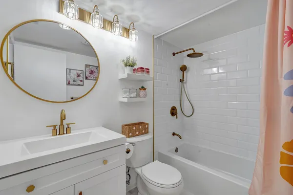 a bathroom with a sink a toilet and a mirror