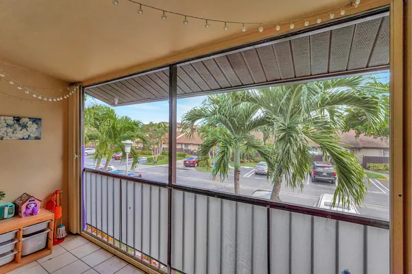 a view of a backyard with a large tree and wooden fence