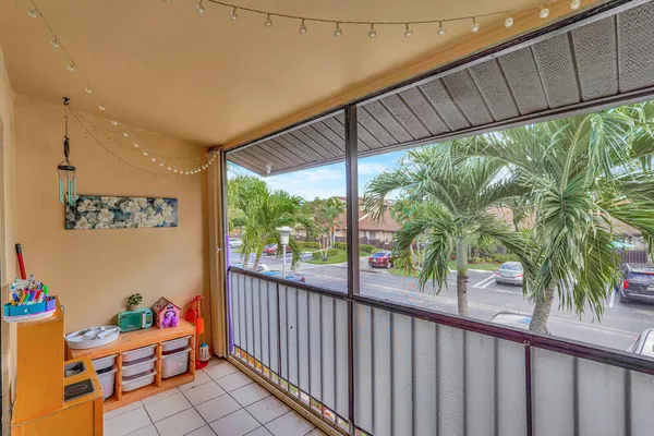a view of a porch with furniture and garden