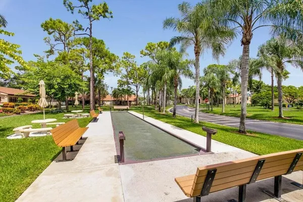 a view of a backyard with swimming pool