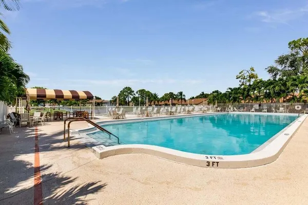 a view of a swimming pool with a yard