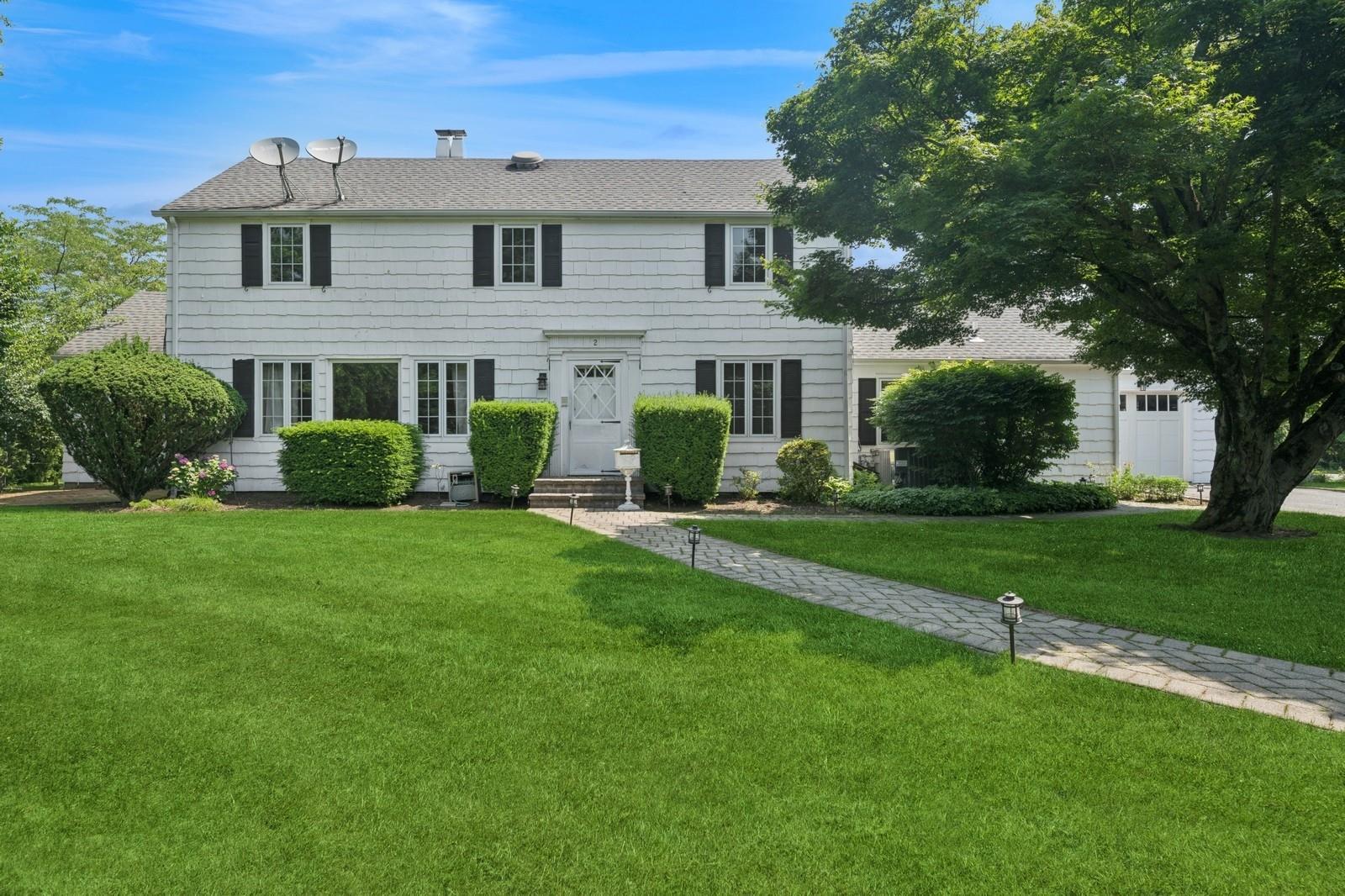 1250 Harbor Road Hewlett, NY 11557 - Photo 1 of 1 a front view of a house with a yard and trees