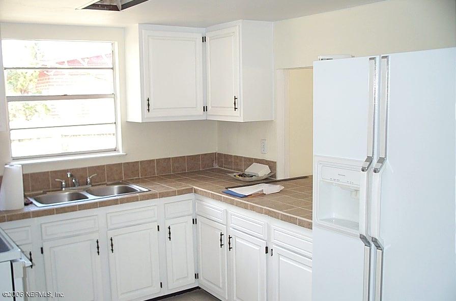 6524 Brandemere Road South Jacksonville, FL 32211 - Photo 3 of 4 a kitchen with a sink and cabinets