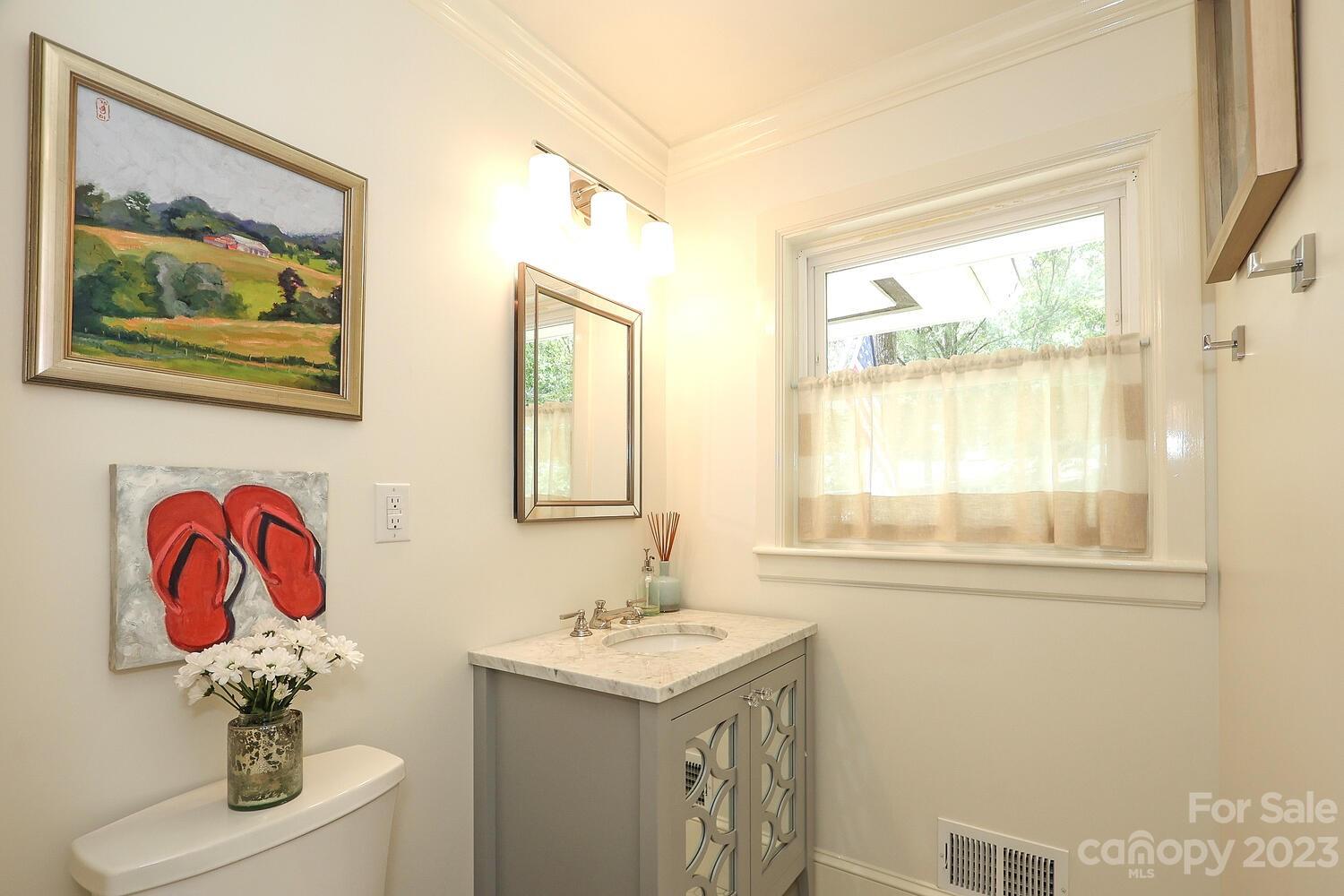 5529 Seacroft Road Charlotte, NC 28210 - Photo 11 of 14 a bathroom with a sink and a mirror