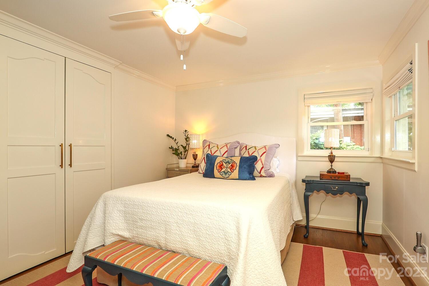 5529 Seacroft Road Charlotte, NC 28210 - Photo 7 of 14 a bedroom with a bed and wooden floor