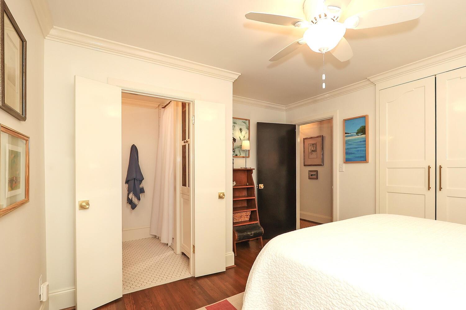 5529 Seacroft Road Charlotte, NC 28210 - Photo 8 of 14 a spacious bedroom with a bed and a chandelier